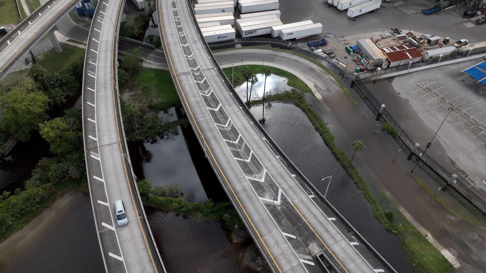 Aerial view of flooded highway infrastructure — climate risk to industrial assets