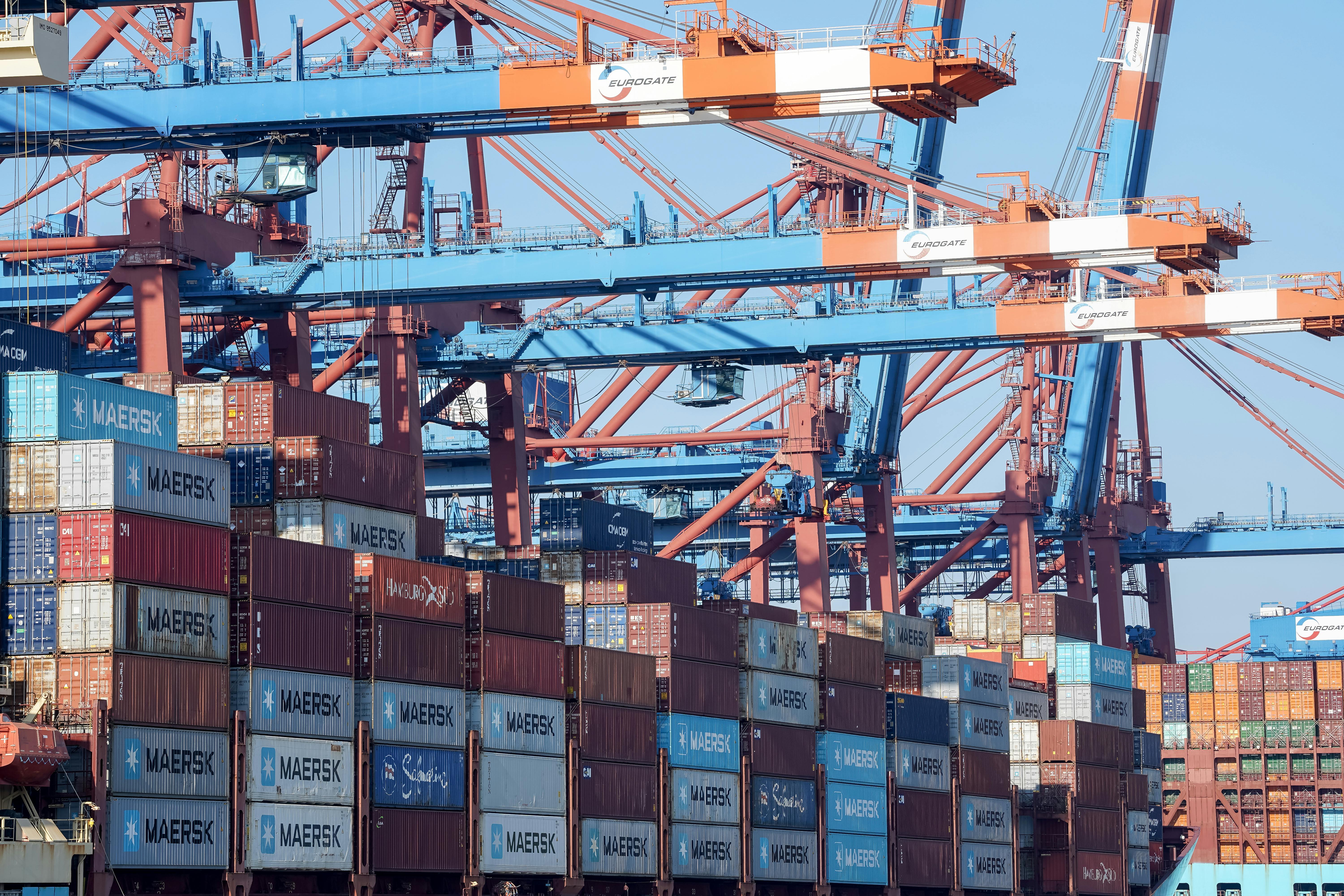 Container port with Maersk shipping containers and cranes, global supply chain infrastructure